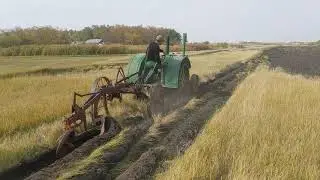 Turning sod - 1937 John Deer D pulling International breaking plow