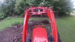 Loading Brush with the Kubota l3560 and BH92 Backhoe.