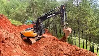 Hyundai Excavator Carving a Road Through Untouched Mountain Jungle