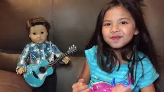 American Girl boy doll Logan playing guitar
