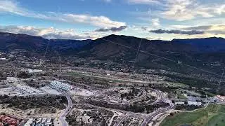 Dusk landscape with neighborhood and roads, Nighttime aerial of community with golf and highways