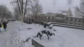 Walking through the snow in Ljubljana: the dog statue by #JakovBrdar on Butcher's Bridge