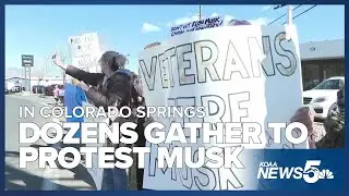 Protesters turned up outside the Colorado Springs Tesla dealership on Saturday in Motor City