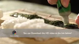 Putting wasabi on the nori while cooking sushi rolls