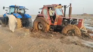 New Holland Tractor pulls another tractor stuck in mudجرار يسحب جرار آخر عالق في الوحل