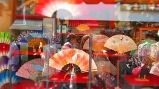 Reflections of People walking in the window of a fan store in Kyoto Japan MVI_5683