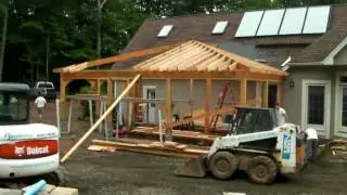 The building of a poolscape, covered outdoor kitchen and pool house surrounding this Gunite pool