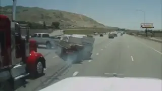 Big rig Semi truck hits trailer and causes a major roll over