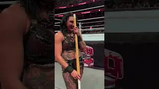 Rhea Ripley beats Dominik Mysterio with a kendo stick after he fell from the shark cage! #wwe