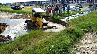 Great skill operator bulldozer pushing soil build new with dump truck unloading soil landfilling up