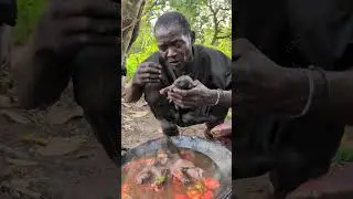 Hadzabe sharing a traditional meal in the wild.