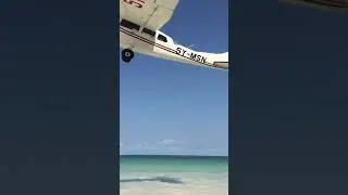 Plane flying low over DIANI Beach