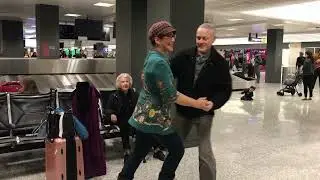 Rusty & Tom dance for Jean Veloz whilst waiting for bags at the airport