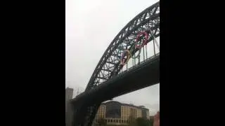 Bear Grylls in Newcastle zip-wire, with London 2012 torch.
