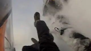 Snowmobile roll over on a hill