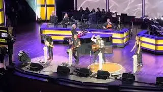 Andrew Farriss and Keith Urban performing Never Tear us Apart at the Opry