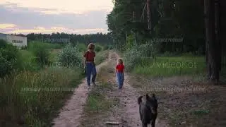 Scenery of woman and little girl walking in a meadow with their black talk and having conversation