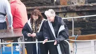 Emma Thompson and Ruth Watkins, entertain a seal, Down Cemetery rd, Newquay.