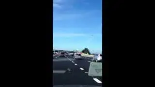 Space shuttle over the bay bridge toll plaza.
