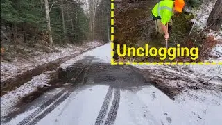 Unclogging Culvert To Stop Water From Crossing The Road
