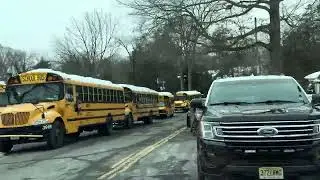 School Buses Parked at Millburn Middle School in the Snow
