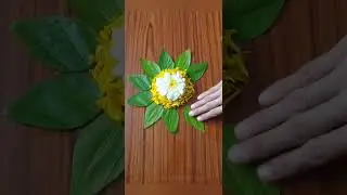 Small rangoli with flowers petals and leaves