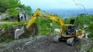 Excavator Trucks at Work: Spreading Construction Material on a Hill Road &ndash; A Spectacular Scene!