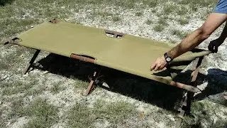 Армейские раскладушки: простой способ натянуть второй конец стержня на боковые штифты направляющей.
