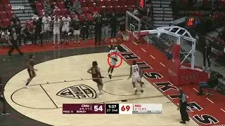 Northern Illinois player scores layup while holding shoe in his other hand
