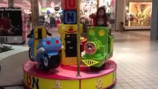 Elijah riding the carousel at the mall