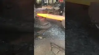 Powerful hydraulic machine hammering red hot metal, amazing forging process
