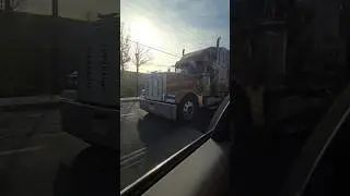 Orange Freightliner Flatbed Semi Truck