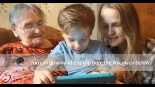 Family uses tablet sitting on the sofa