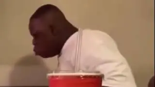 Man falls out chair while eating canes chicken
