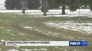 Vehicles drive through Whiteland Christmas light display