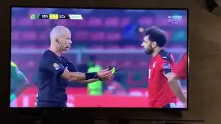 The referee offers his whistle and cards to Mo Salah after...