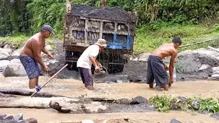 manual miners load sand into dump trucks