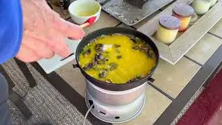 Cheesy garden scrambled eggs on the Trangia