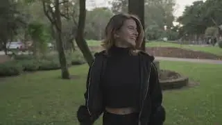 Joyful Woman Spinning and Dancing in Lush Park Setting