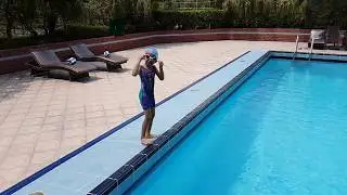 Small girl swimming in deep pool