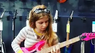 Girl Testing Pink Guitar At Guitar Center