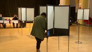 Those who didn't vote early brave rain to get to polls