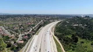Aerial view of bridge construction crossing the highway in California | Free Stock Video