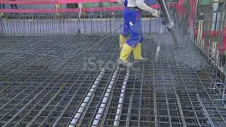 Workers Directing Concrete Onto The Construction Site stock video