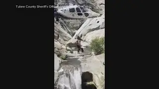 Video shows dramatic rescue of a hiker stuck behind a waterfall in California