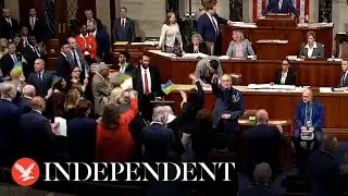 Representatives celebrate and wave flags after US Congress passes Ukraine aid package