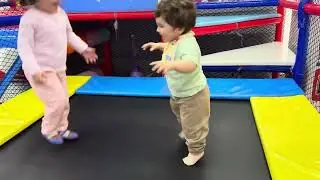 Myla and Sam playing on the Slides and Trampoline Playground