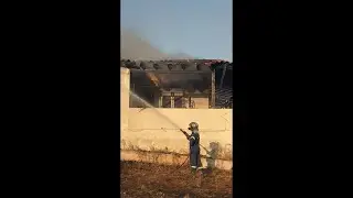 Firefighter Extinguishes House Fire Caused By Wildfires in Athens, Greece