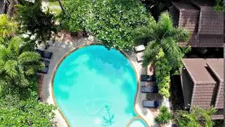 Aerial flying drone view of swimming pool in luxury 5 star resort on sunny tropical paradise island