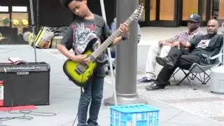 Black kid playing heavy metal music on guitar in New York